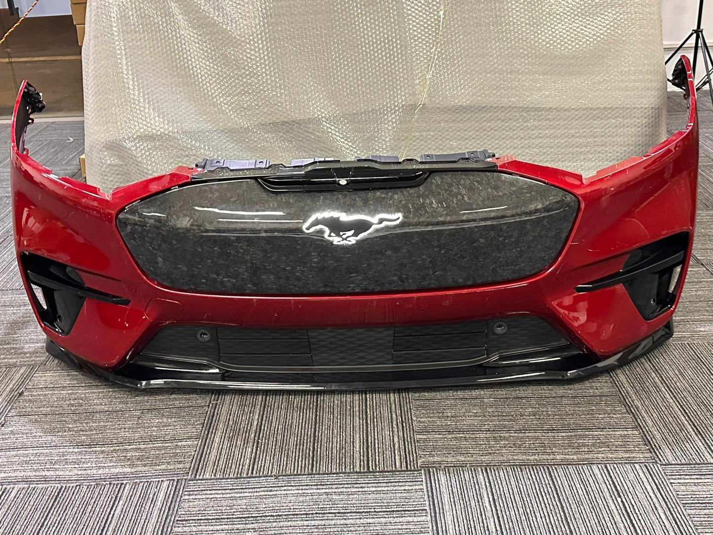 Red Mustang Mach-E front bumper with carbon fiber GT GRILL V2 featuring illuminated pony emblem