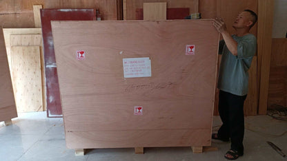 Man inspecting large wooden crate packaging for Shelby Style Fiber Hood shipping protection