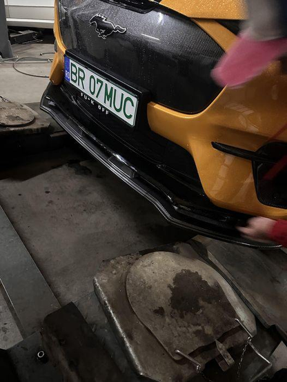 GT Grill V1 wet carbon fiber grille installed on yellow Mustang Mach-E GT 2021-2025 front bumper