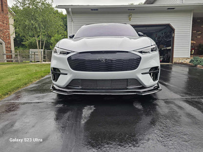 Front Lip Splitter in wet carbon fiber installed on white Mustang Mach-E GT (2021-2025) parked in driveway