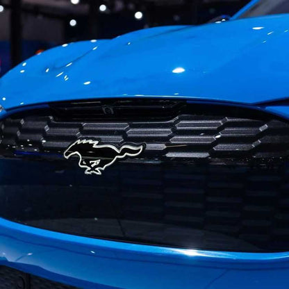 Illuminated GT Pony Kit on blue Mustang Mach-E GT front grille close-up