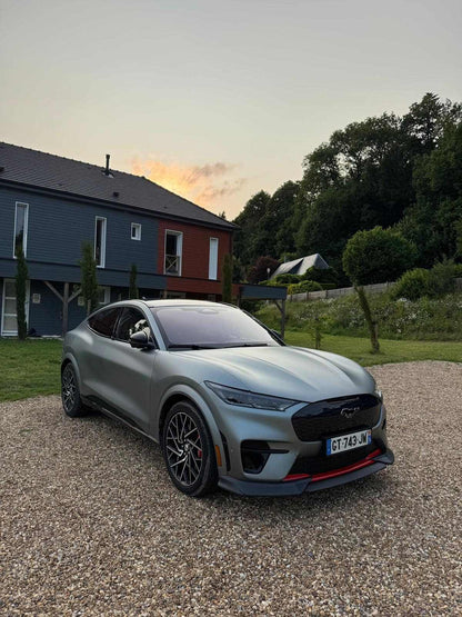 Mustang Mach-E GT with front lip splitter installed on gravel driveway