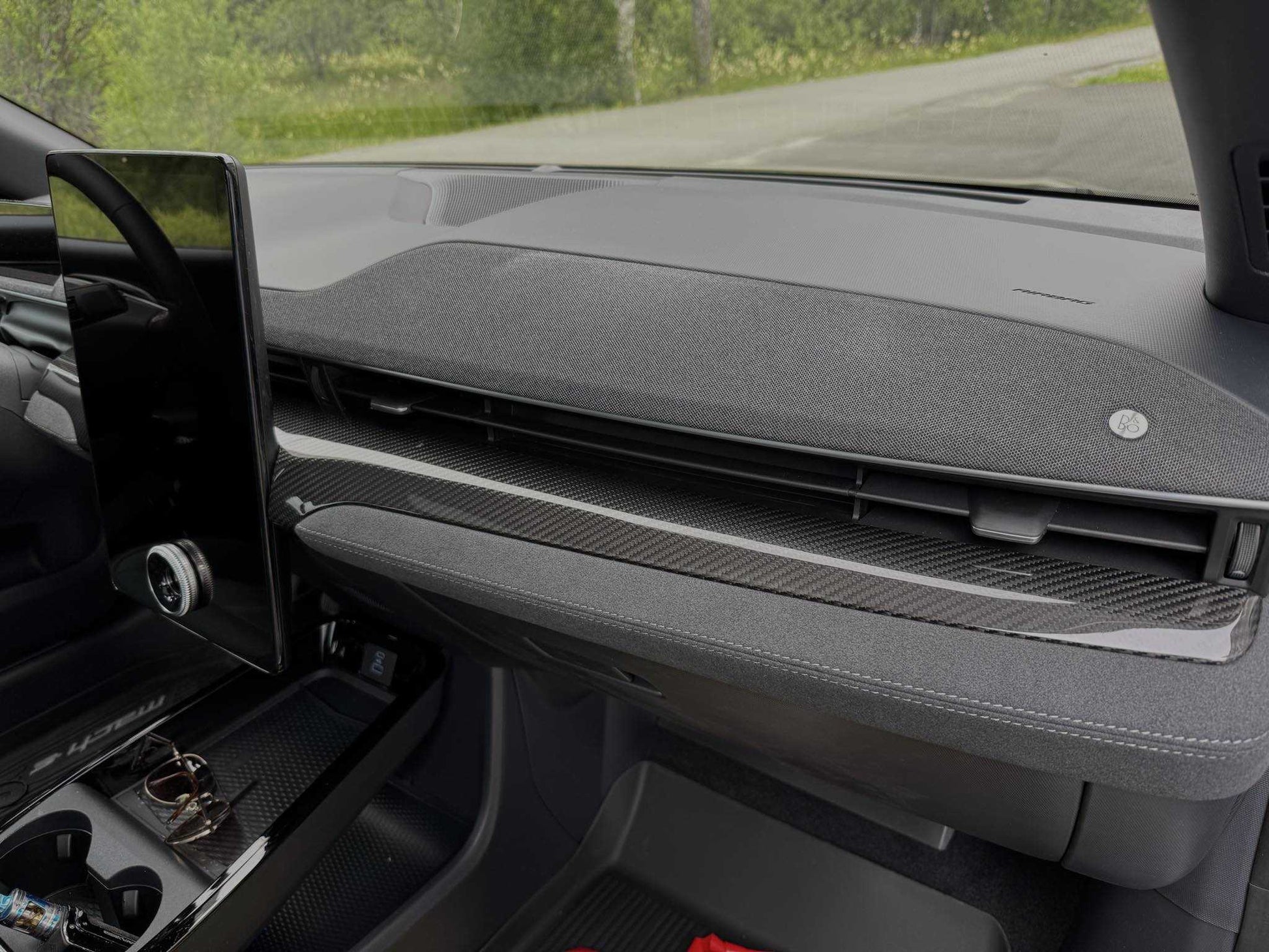 Dry carbon fiber dash panel installed on a 2021-2025 Ford Mustang Mach-E interior.