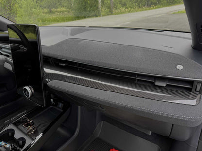 Dry carbon fiber dash panel installed on a 2021-2025 Ford Mustang Mach-E interior.