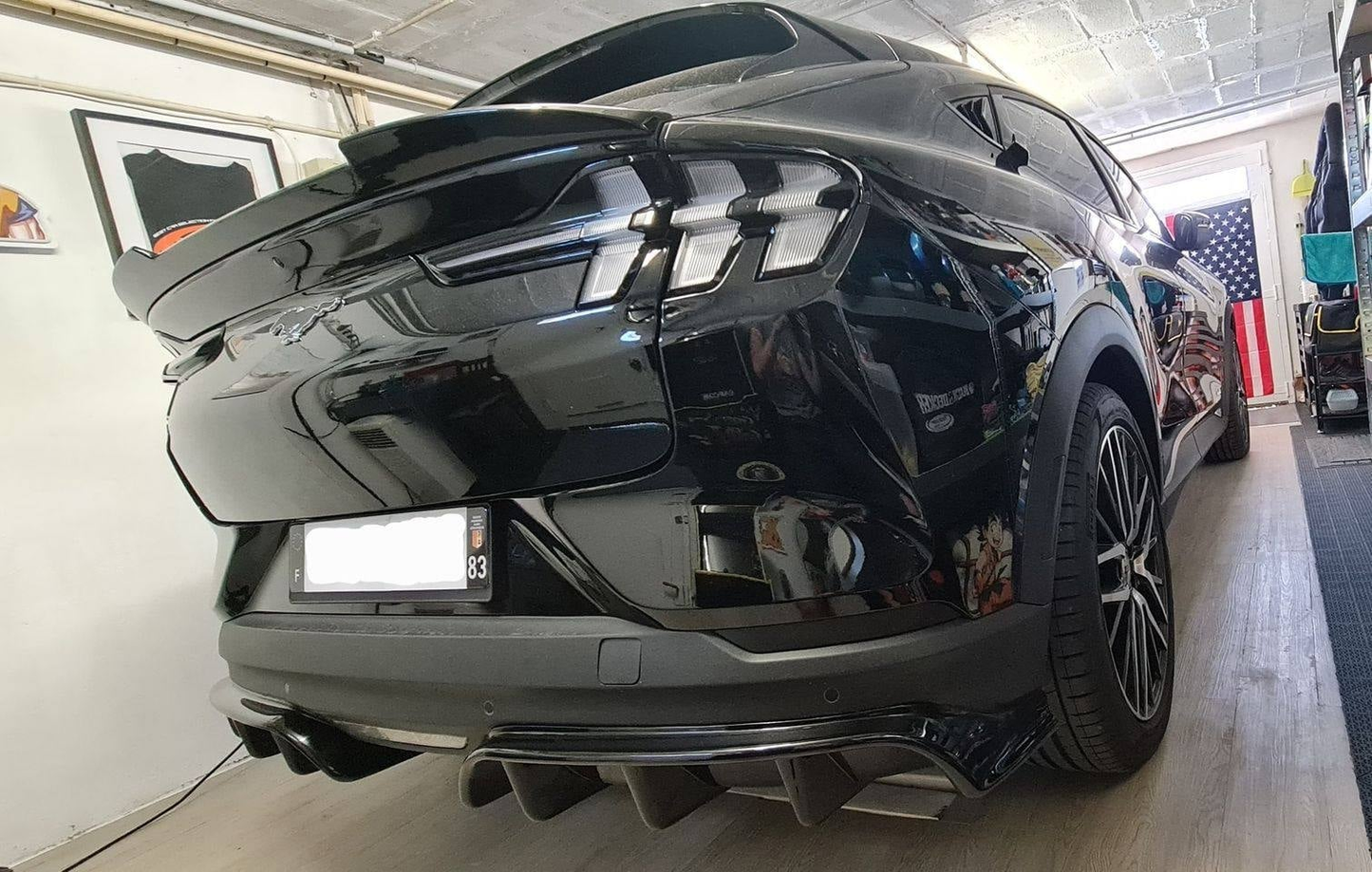 Rear view of black Mustang Mach-E featuring Spoiler V2 wet carbon fiber aerodynamic upgrade
