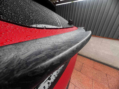 Wet carbon fiber Spoiler V2 installed on red Mustang Mach-E rear trunk for improved aerodynamics and sporty look