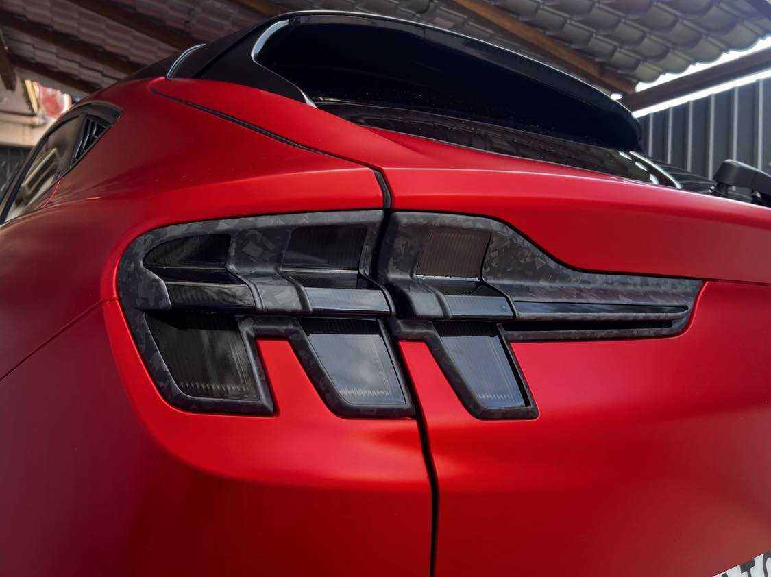 Rear view of red Mustang Mach-E with Spoiler V2 in carbon fiber installed