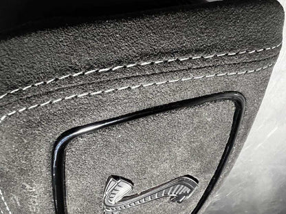 Close-up of Ford center airbag with black Alcantara material and light grey stitching for Mustang Mach-E interior customization