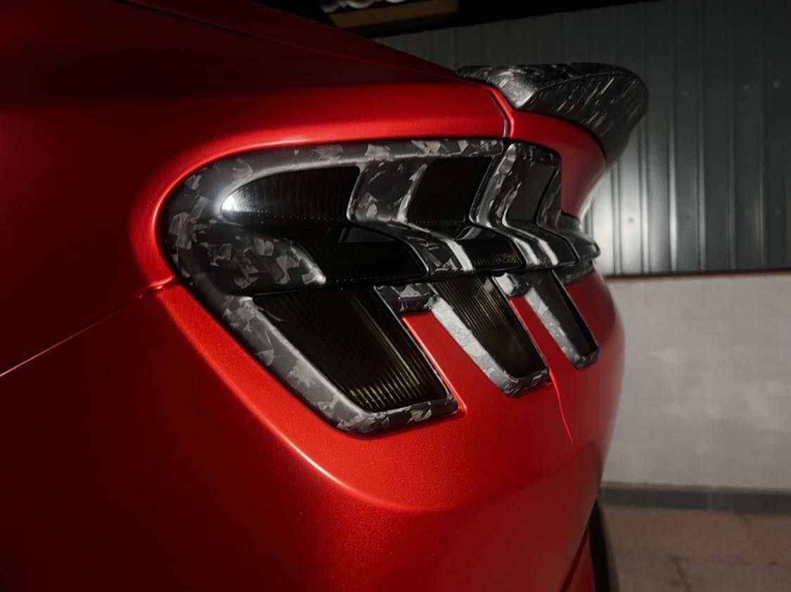 Spoiler V2 for Mustang Mach-E rear view with wet carbon fiber finish on red car