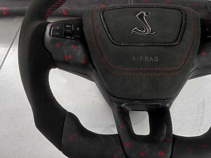 Custom made steering wheel for Mustang Mach-E with Alcantara grip, red stitching, and integrated multifunction buttons