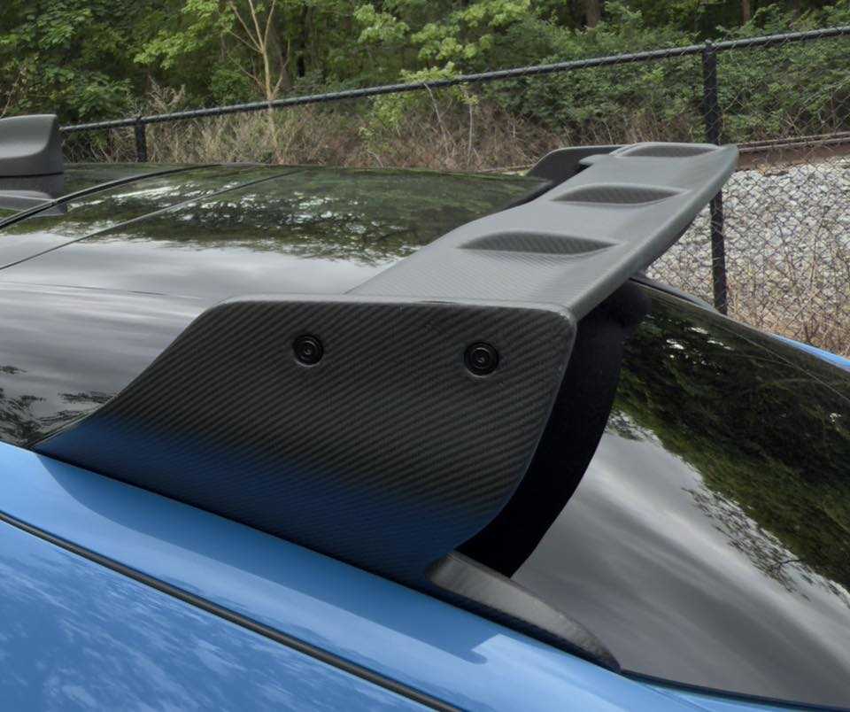 Carbon fiber Rally Wing Spoiler on rear of blue Ford Mustang Mach-E for enhanced aerodynamics and sporty look