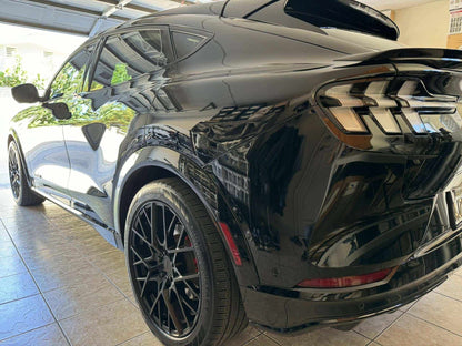 Black Mustang Mach-E with Spoiler V3 trunk spoiler installed, showcasing rear and side view.