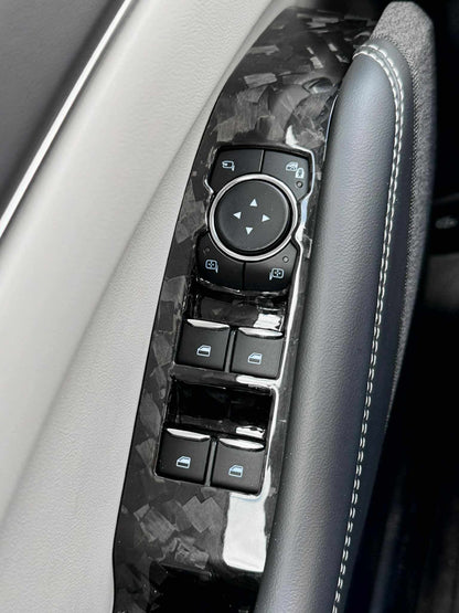 Dry Carbon Fiber Dash close-up on Mustang Mach-E door control panel with sleek black weave finish