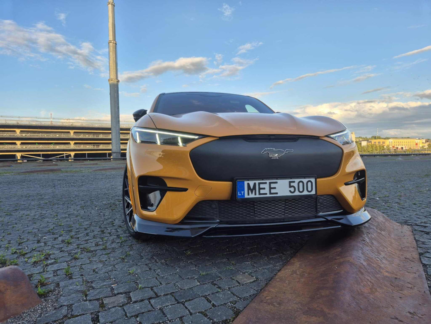Mustang Mach-E GT with installed wet carbon fiber front lip splitter in black enhancing sporty look and aerodynamics