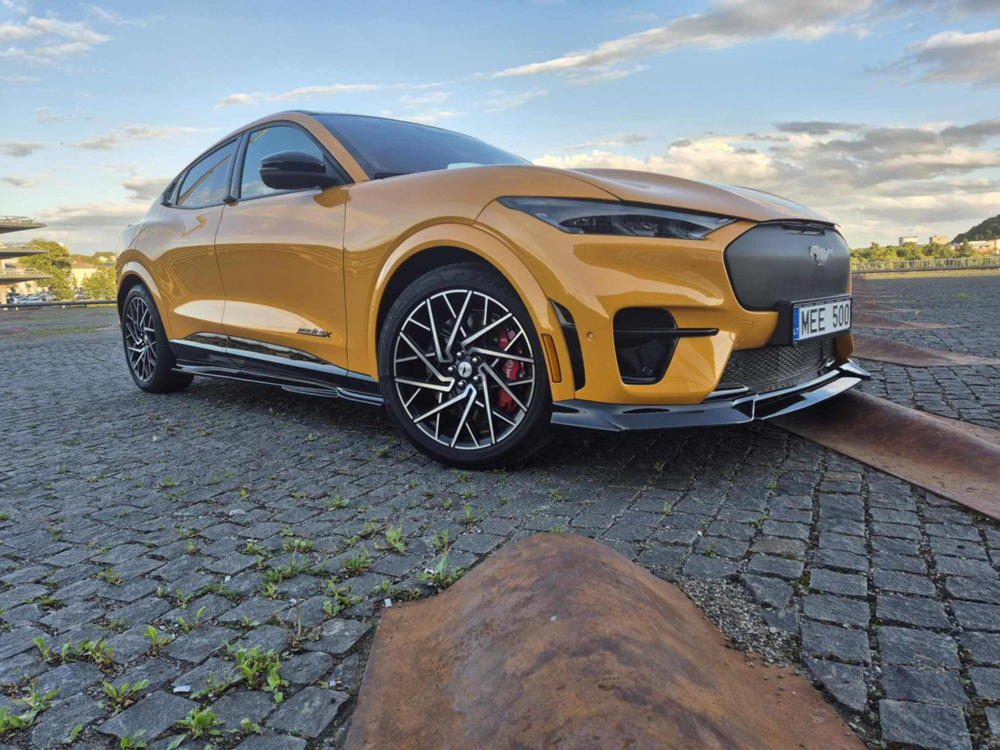 Mustang Mach-E GT with carbon fiber front lip splitter installed on yellow body