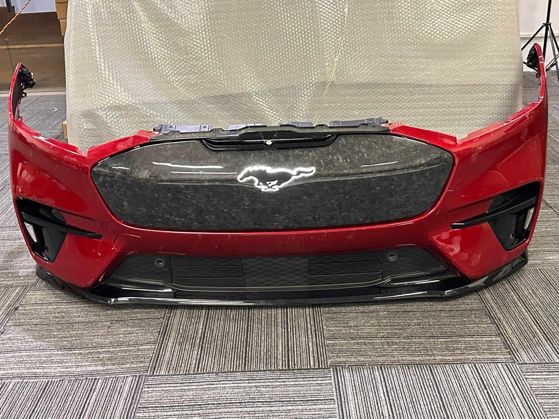 Red Mustang Mach-E front bumper with carbon fiber GT GRILL V2 featuring illuminated pony emblem