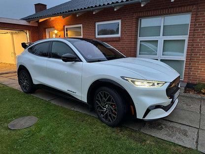 White 2021-2025 Ford Mustang Mach-E with Rally Wing Spoiler installed on rear in residential driveway