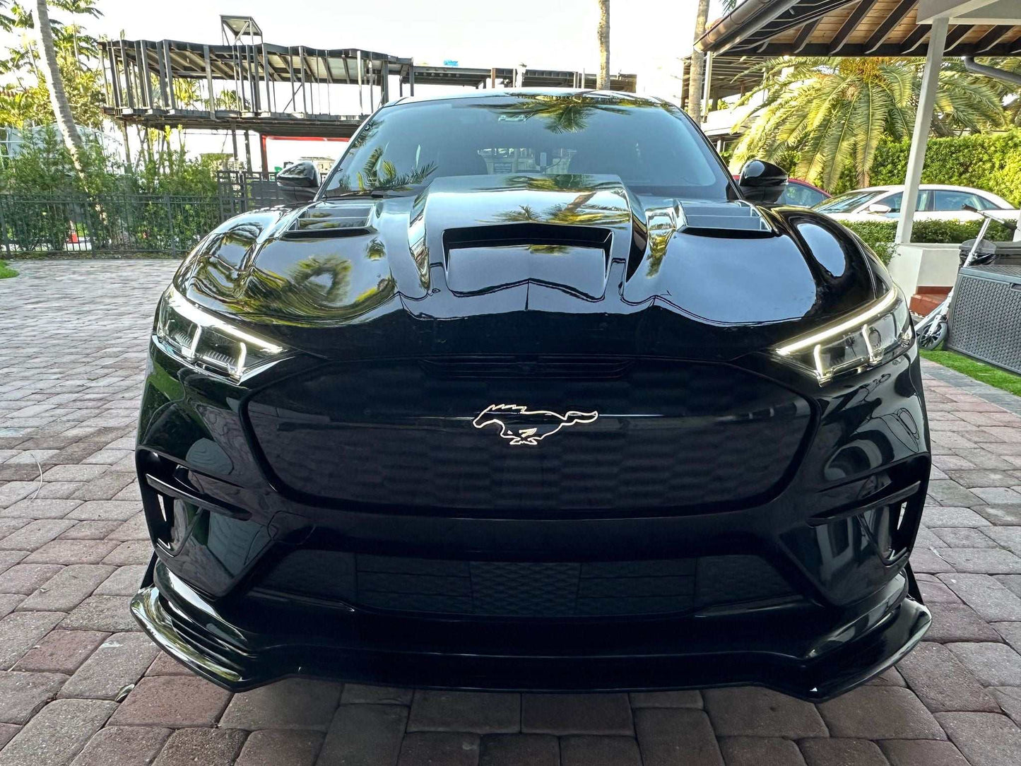 Front view of black Mustang Mach-E with Shelby GT550 style carbon fiber hood and vents