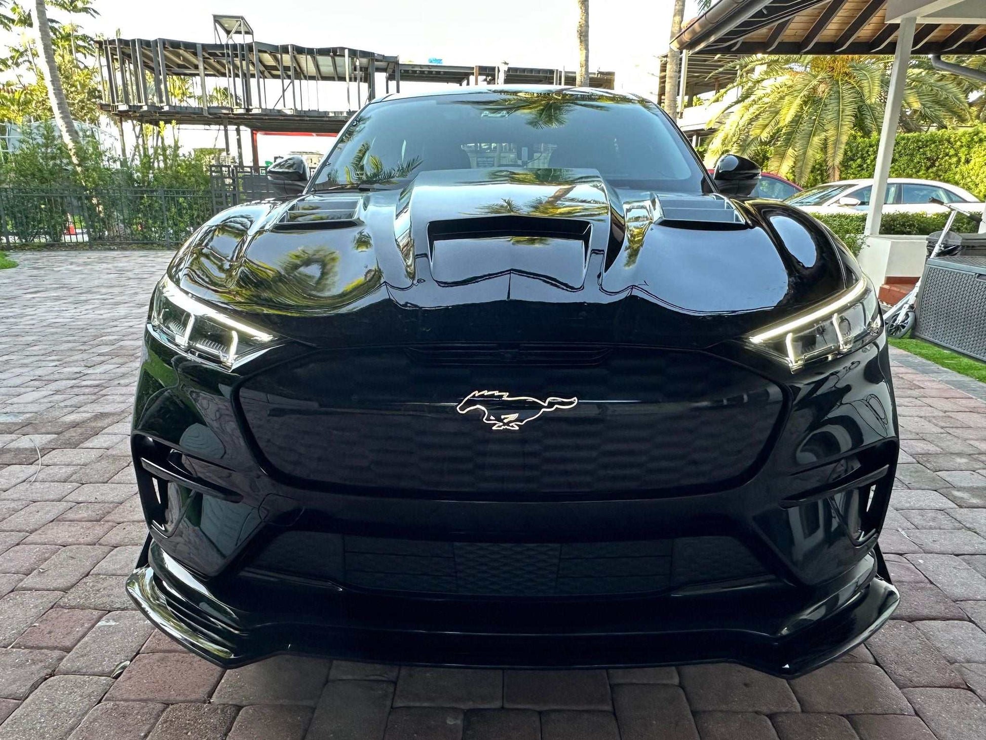Front view of black Mustang Mach-E with Shelby GT550 style carbon fiber hood and vents