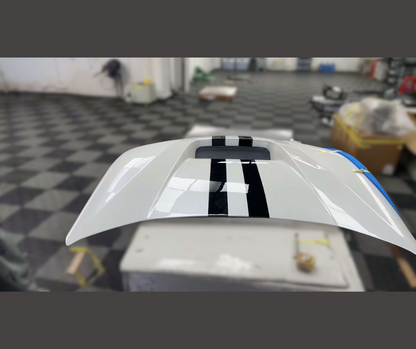 Shelby Style Fiber Hood for Mustang Mach-E 2021-2025 with sleek white finish and black racing stripes, lightweight and aerodynamic design