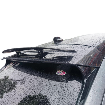 Retractable spoiler installed on rear window of black Mustang Mach-E with raindrops