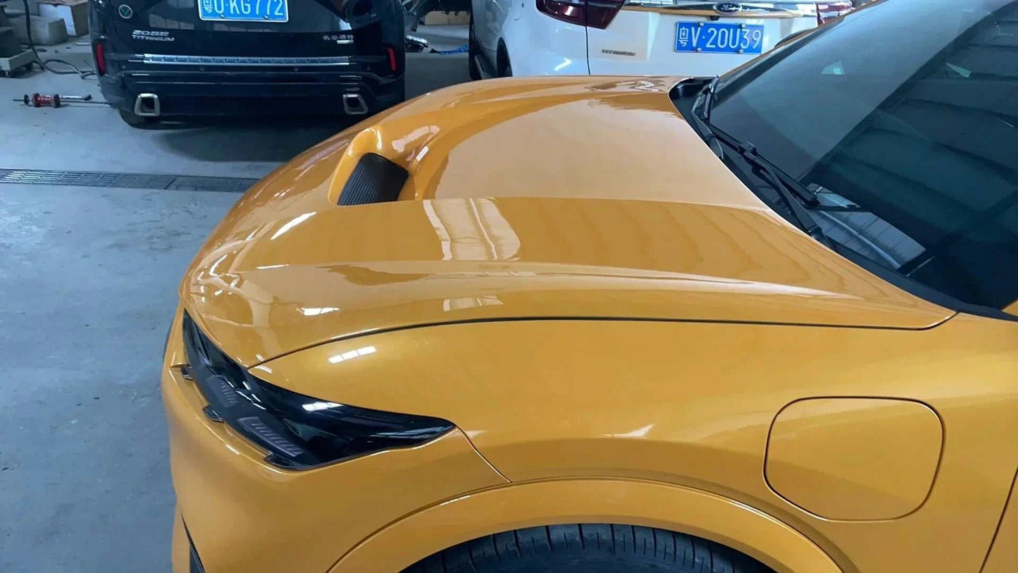 Yellow Ford Mustang Mach-E with installed Shelby Style Fiber Hood featuring carbon fiber vent design