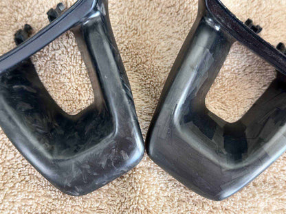 Premium black steering wheel trim pieces for Mustang Mach-E with glossy finish on beige fabric background