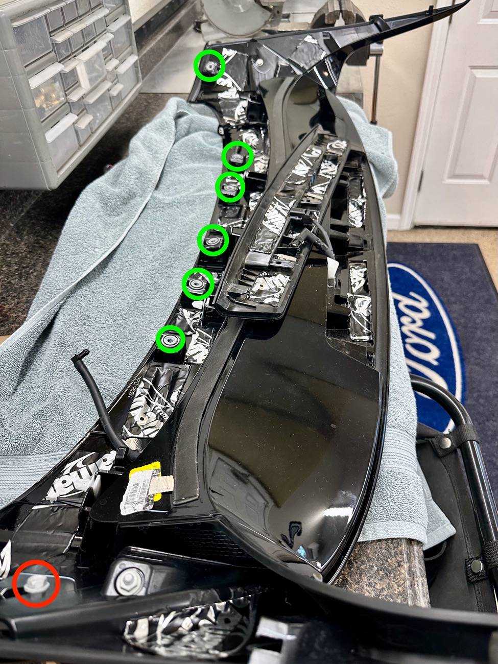 Retractable spoiler for Mustang Mach-E with advanced aerodynamics and sleek design, shown from the underside with mounting points.