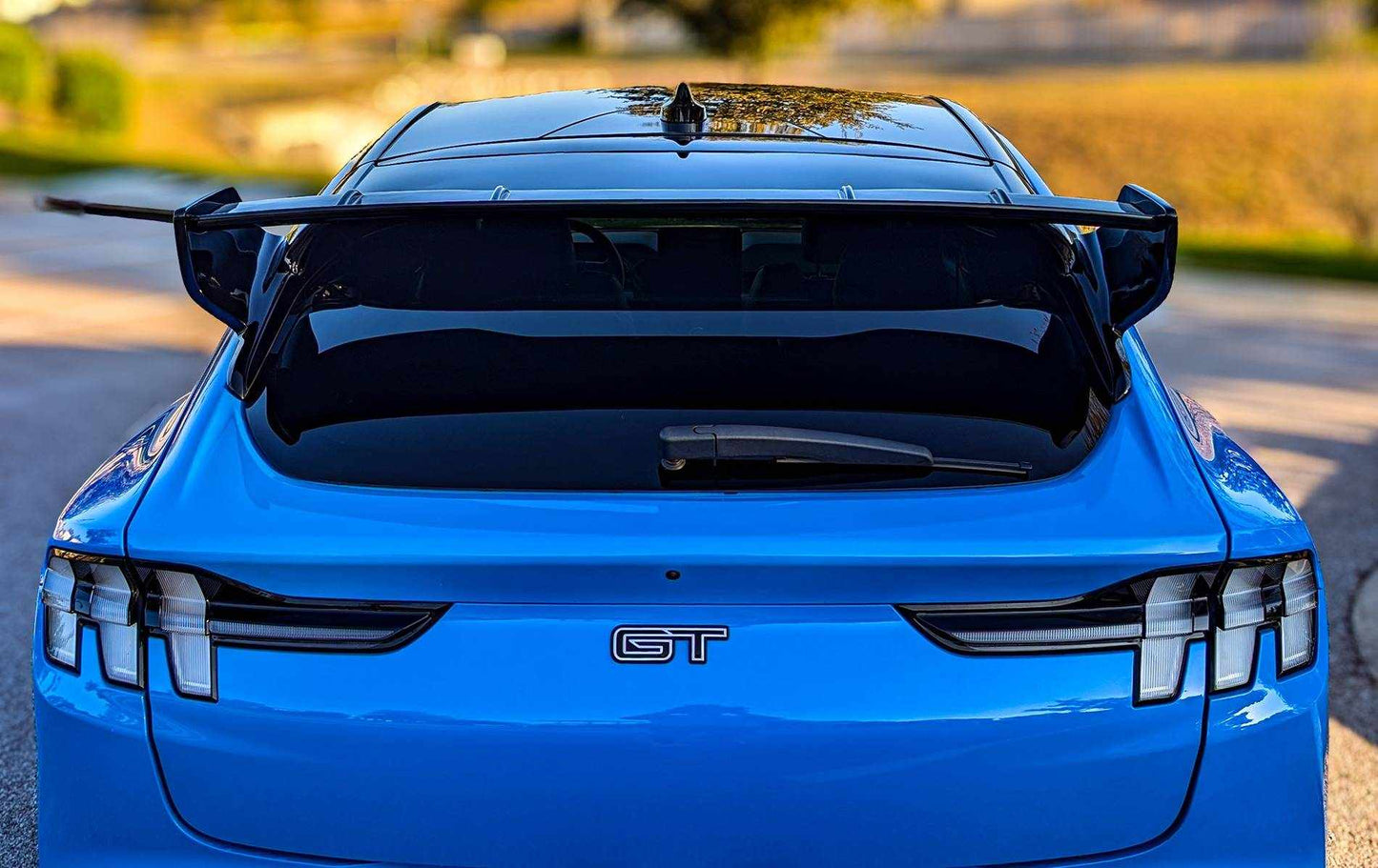 Blue Ford Mustang Mach-E GT with black Rally Wing Spoiler installed on rear hatch