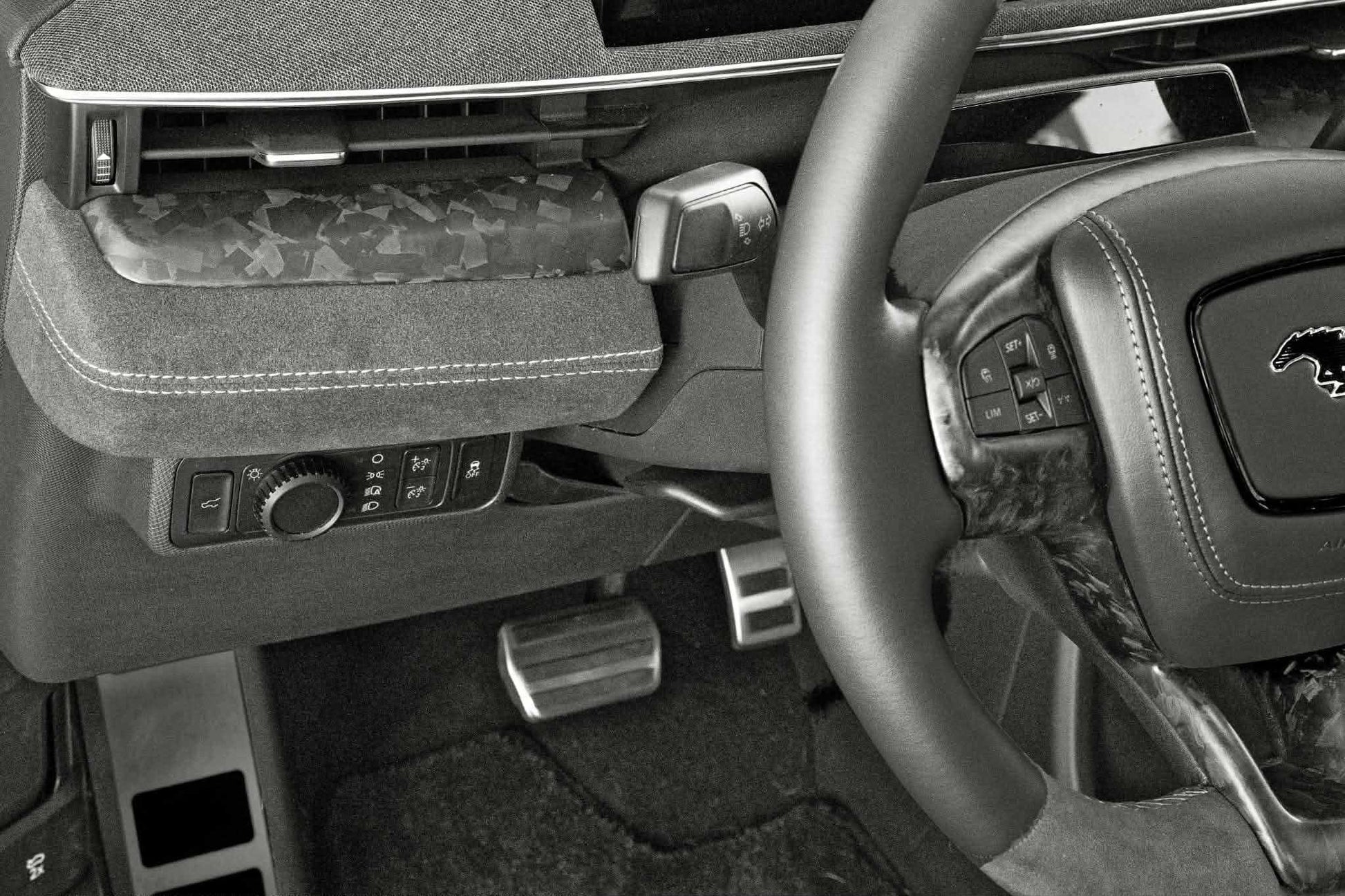 Dry carbon fiber dash panel installed in Ford Mustang Mach-E interior with forged carbon finish and steering wheel details