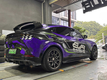 Side skirts for Mustang Mach-E installed on a black and purple custom Mustang Mach-E in a garage