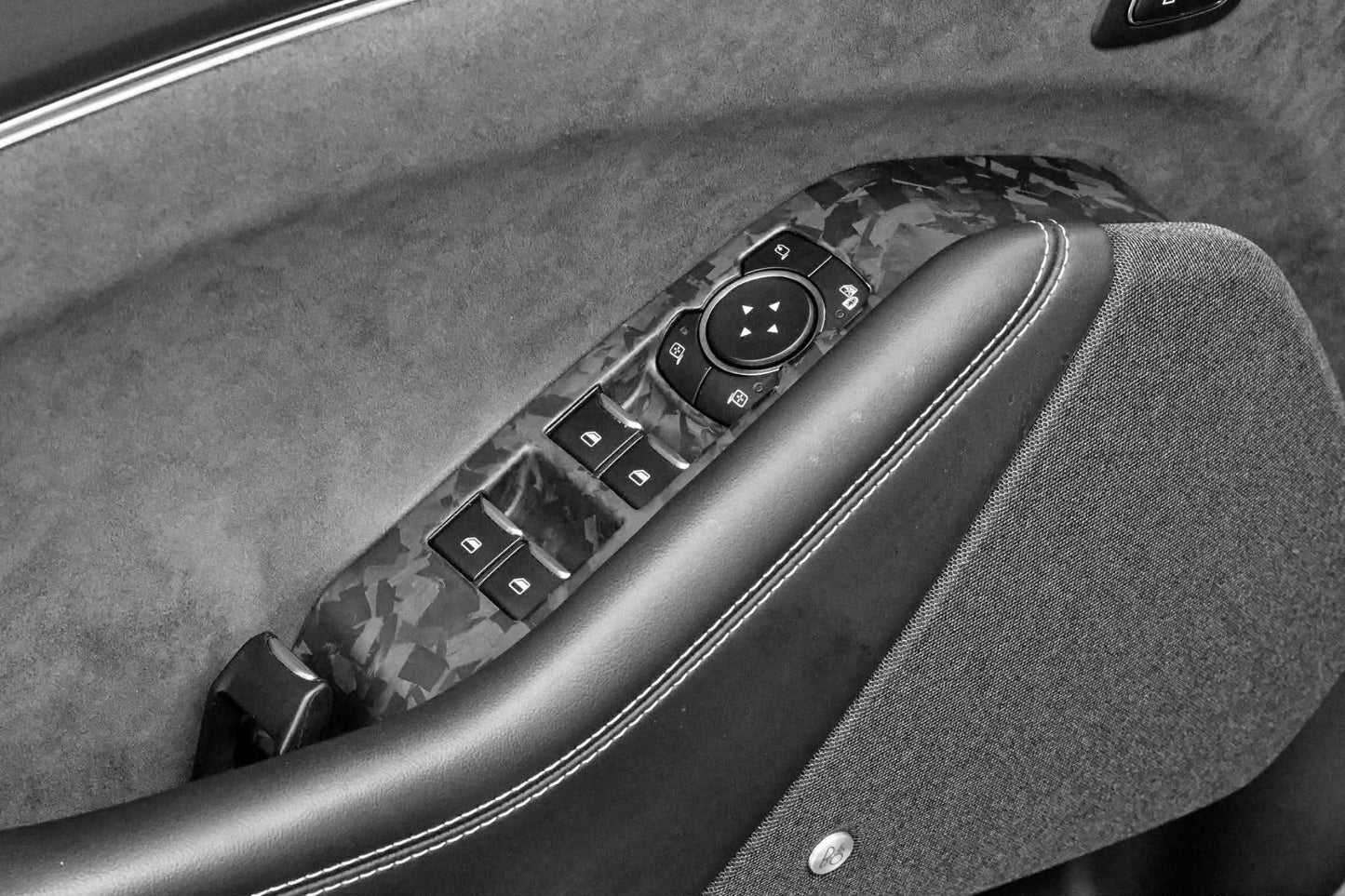 Dry carbon fiber window control panel trim in black and gray interior of Mustang Mach-E
