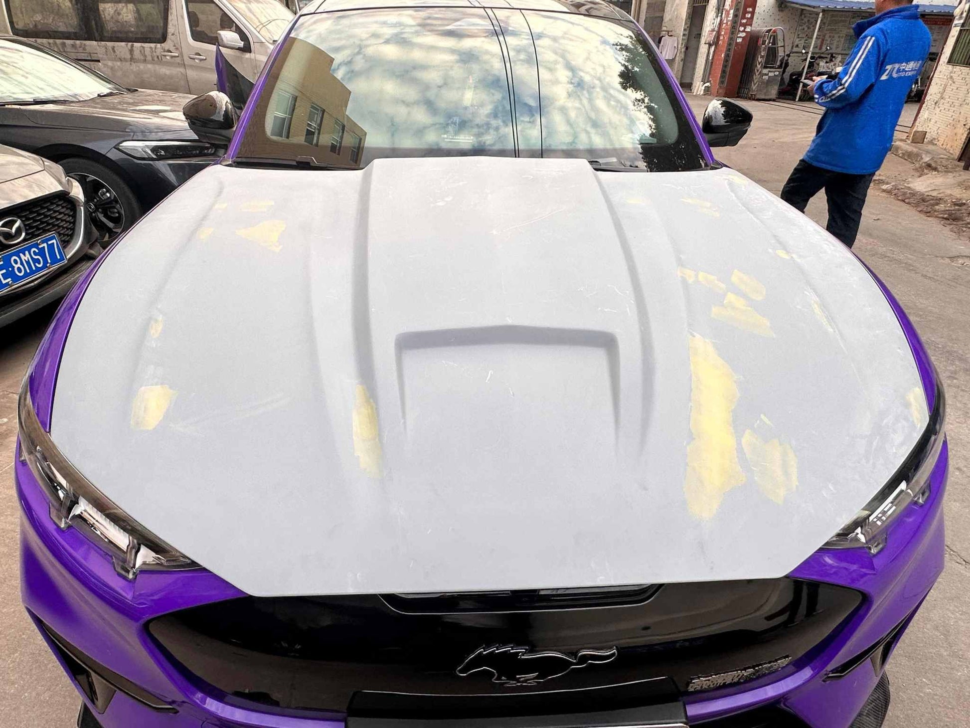 Ford Mustang Mach-E with aftermarket GT550 style fiber hood in primer finish