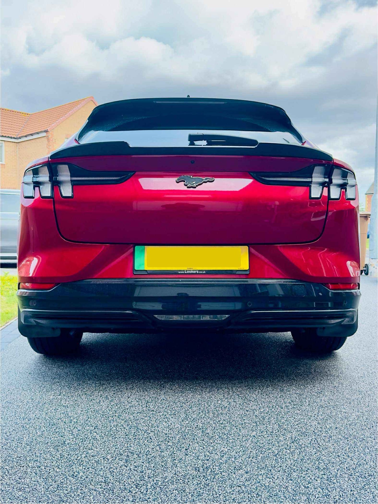Rear view of red Mustang Mach-E with Spoiler V2 installed