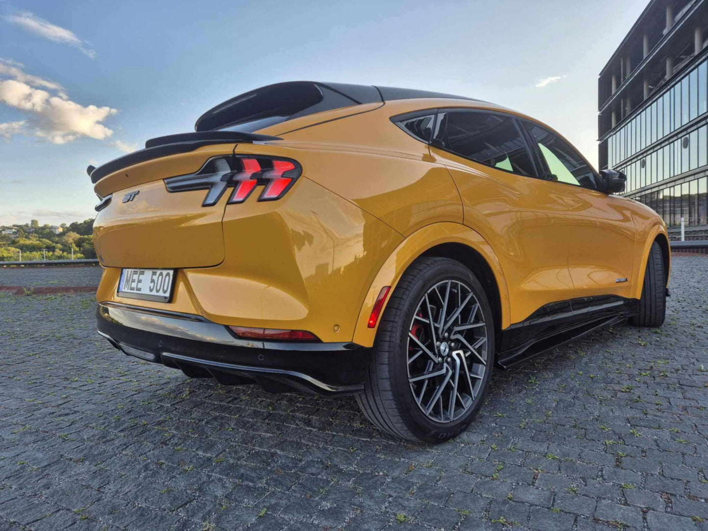 Yellow Mustang Mach-E 2021-2025 with Spoiler V3 fender to fender carbon fiber trunk spoiler installed