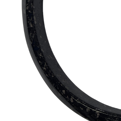 Close-up of a carbon fiber wider fender flare edge with textured finish for vehicle upgrade