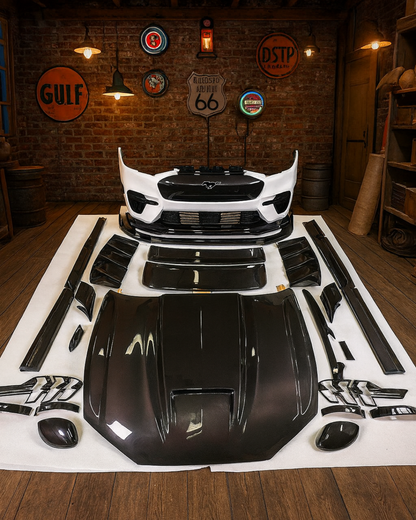 Full bodykit for Mustang Mach-E 2021-25 including hood, front lip, side skirts, diffuser, and spoilers displayed in workshop setting