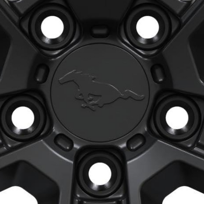 Black forged metal Mach-E center cap with Mustang horse logo and precision fit design