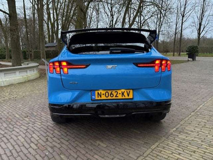 Blue Ford Mustang Mach-E with black Rally Wing Spoiler installed on rear trunk for enhanced aerodynamics and sporty look